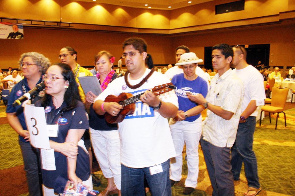 Hawaiian Affairs Caucus members serenade outgoing Democratic Party Chair Cante Carpenter at the 2014 State Democratic Convention.